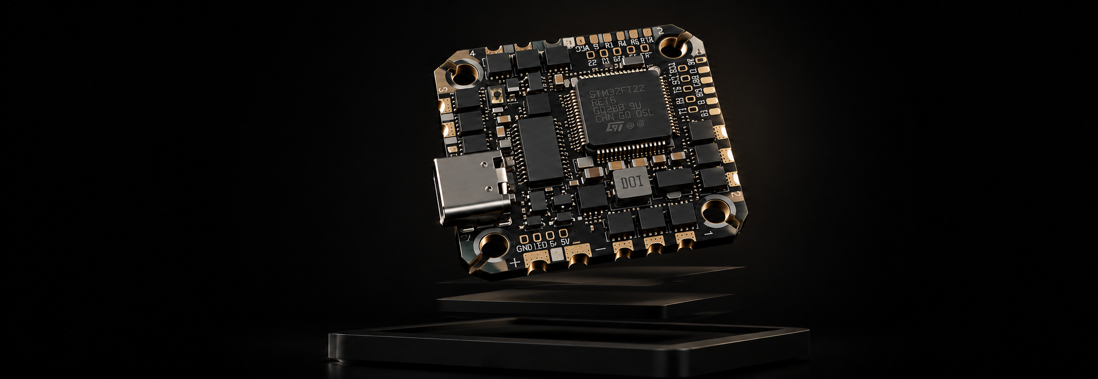 A compact electronic circuit board with a central processor chip, gold-plated connectors, and a USB-C port, shown floating above a dark platform against a black background.