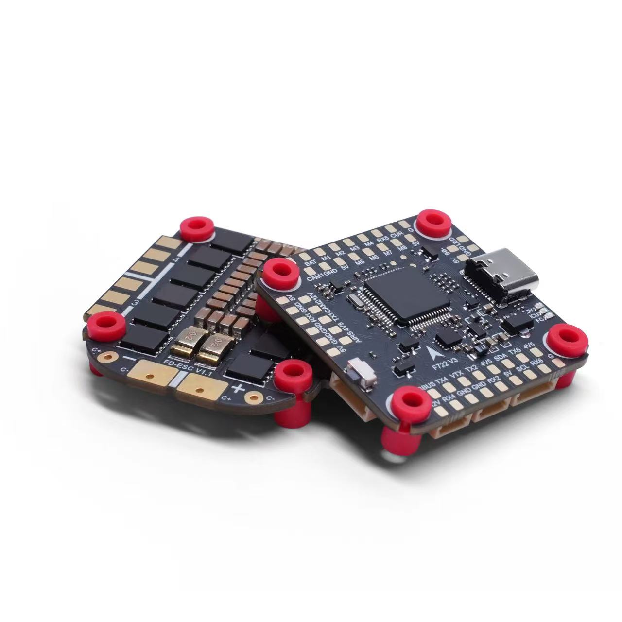 Two small electronic flight control boards with black circuitry and bright red corner mounts, photographed on a clean white background.