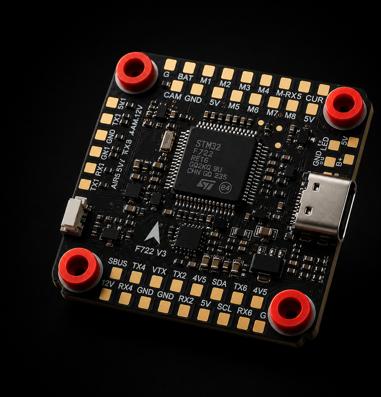 A STM32 F722 microcontroller flight control board with a black PCB, gold-plated pads, a central processor chip, a USB-C port, and four red terminal screws, shown on a black background.